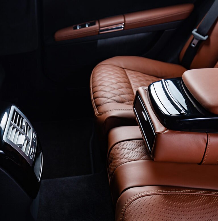 A luxury car interior in brown and black colors